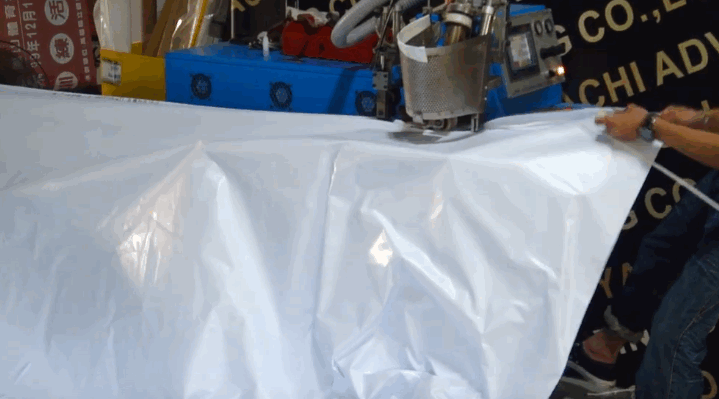 Hemming machine for tarpaulin